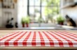 © sangkribo - Red checkered tablecloth on wooden table in blurred kitchen.