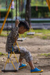© themorningglory - Kindergarten asian boy enjoy play swing bar outdoor playground