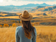 © Milla - Portrait of happy carefree woman enjoying freedom against autumn field meadow, mountain and sky cloud background. Holiday vacation and travel concept