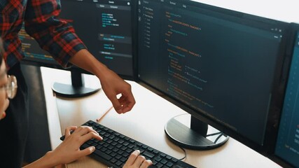 Slow motion back end or software developer manager supervising his team on new application program development on debugging and solving complex code algorithms on monitor. Burgeoning