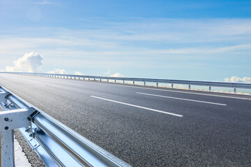 Wall Mural - Asphalt road and sky clouds scenery under blue sky. Outdoor road background.