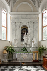 Wall Mural - A white church with a statue of Jesus Christ in the middle