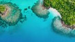 © HoursStudio - Aerial view of vibrant turquoise waters with coral reefs and lush green islands, showcasing a stunning tropical landscape.