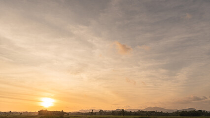 Wall Mural - sunset sky clouds in the evening with colorful orange sunlight over mountains in golden hour or sunr