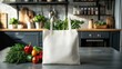 © Vikarest - White eco friendly shopping bag with fresh vegetables. Linen tote shopper bag on modern kitchen table