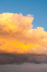 Wall Mural - sunset sky background, scenic sunset golden clouds lit by colorful evening sunlight
