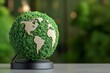 © Sanchai - A globe made entirely of green foliage and trees, symbolizing environmental conservation and sustainability