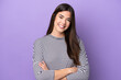 © luismolinero - Young Brazilian woman isolated on purple background keeping the arms crossed in frontal position