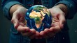 © Olga - Hands holding planet Earth close-up