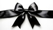 © Jawad - A black satin bow is centered against a white background.