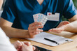 © dsheremeta - Doctor offering three different blister packs of medication to a patient, close-up shot.