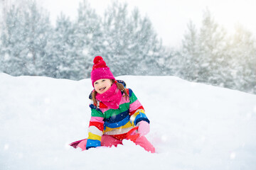 Wall Mural - Girl on sled ride. Child sledding. Kid on sledge