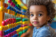 © Yurii Levko - Cute child playing and learning with colorful abacus in kindergarten