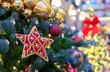 © Valemaxxx - Red star with beads and sequins on a Christmas tree.