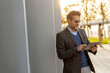 © BGStock72 - Professional man using tablet in urban park during sunset while enjoying the warm glow and peaceful surroundings