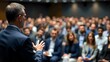 © Kowshar habib - Professional Speaker Presenting to Large Audience, Business Conference Presentation with Gesturing Hands, Public Speaking Engagement, Focused on Presenter, Corporate Event