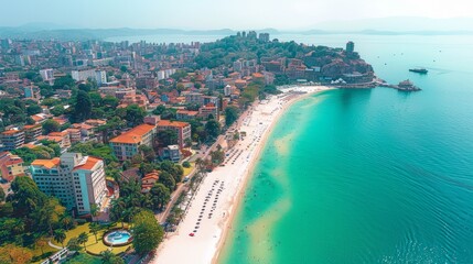 Wall Mural - Aerial view of a coastal city with a beautiful beach, turquoise water, and buildings.