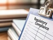 © Tonton54 - financial compliance legislation concept. Regulatory compliance checklist on a clipboard with documents in background.