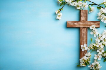 Poster - Wooden cross with spring flowers on blue background with copy space. Religion background. Religious church holidays. Christianity Feast, Easter, Palm Sunday, Christening, church wedding. Flat lay 