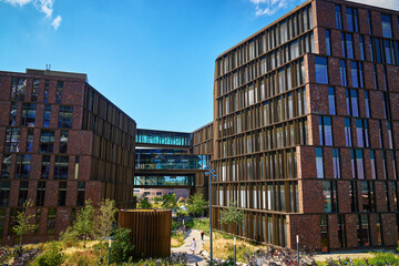 Wall Mural - Residential district in Copenhagen, Denmark. Modern city architecture with eco friendly buildings. Urban setting with contemporary office buildings and walking people