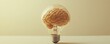 © Itsaree  - A brain encased in a light bulb on a clean, empty background with copy space, symbolizing innovative thinking, knowledge generation, and brainstorming creativity