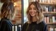 © GRACE - Client smiling in the mirror after receiving a fresh hairstyle from a talented stylist.