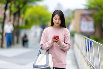 Wall Mural - Female traveler using cellphone in Taipei city