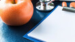 © Sirathee - Diabetes Prevention and Control Concept, Fresh Apple on Table Next to Stethoscope and Blank Notepad for Community Health and Diabetes Prevention Programs