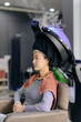 © Jirawatfoto - Asian woman sitting in salon chair undergoing hair steaming treatment with modern steamer