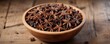 © vilavanh - Wooden bowl filled with star anise on a rustic wooden table, nature-inspired, wooden bowl, aromatic