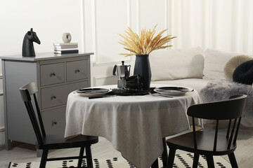 Poster - Stylish table setting with beautiful dishware and black chairs in dining room