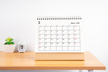 Wall Mural - March 2025, Monthly desk calendar for 2025 year on wooden table.