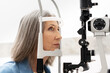 © Maria Vitkovska - Senior woman undergoing eye exam with slit lamp in ophthalmology clinic