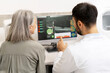 © Maria Vitkovska - Ophthalmologist showing medical exam results on computer to senior patient