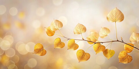 Golden autumn branch with heart-shaped leaves against a soft-focus background