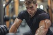 © Сергей Захаров - young man lifting weights in gym focused on his exercise