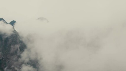 Wall Mural - Mountain Range Shrouded By Fog And Clouds In Peru. - timelapse shot