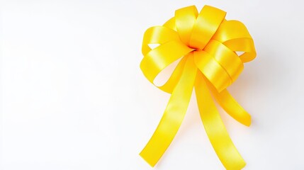 Wall Mural - A vibrant yellow ribbon bow on a white background, perfect for gifts and celebrations, highlighting joy and festivity.