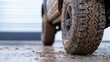 © Raweewit - A close-up view of a muddy tire, showcasing rugged tread patterns, indicating off-road usage and adventure.