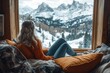 © Lubos Chlubny - Woman relaxing and enjoying stunning winter mountain view from cozy cabin window
