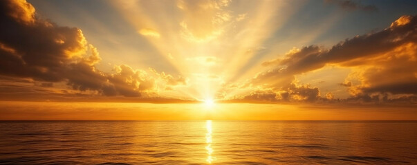Wall Mural - Soft golden and orange light bursts over a tranquil ocean at sunrise, creating a serene and peaceful atmosphere