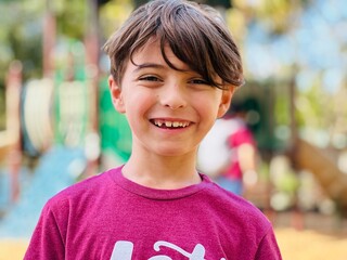 portrait of a child smiling missing teeth 