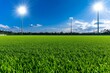 © Thanyarat - A football field with fresh green turf under bright stadium lights, ready for an intense match
