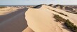 © Patthama - Aerial view of a dune ridge with sandy waves and wind-blown vegetation, aerial view, wavy line, andscape