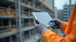 © Awan - Construction Worker Using Tablet on Site