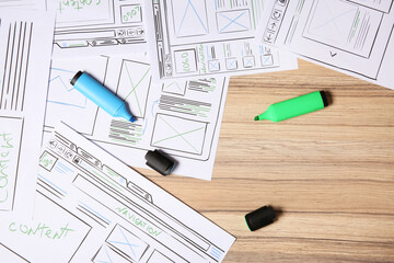 Wall Mural - website development. sketches of wireframes and highlighters on wooden table, flat lay