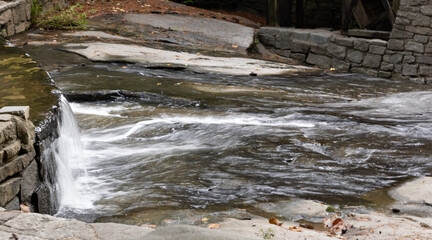 Wall Mural - Water cascading around rocks