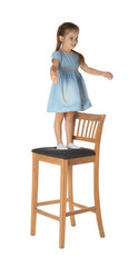 little girl standing on stool against white background