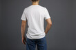 © New Africa - Man in stylish t-shirt on grey background, back view. Mockup for design