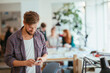 © Geber86 - Young man using a smart phone while working in a startup company office